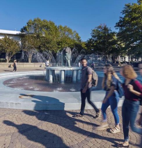 Students walking by Monarch fountain